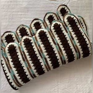 Handmade deep brown, cream, teal, and tan afghan with scalloped detail